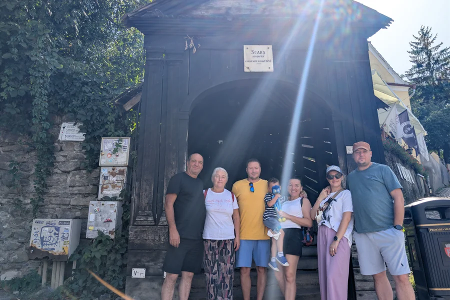 Perspectivă de jos în sus prin Scara Acoperită din Sighișoara — 175 de trepte de lemn construite în 1642, joc de lumini și umbre, obiectiv turistic iconic al cetății medievale